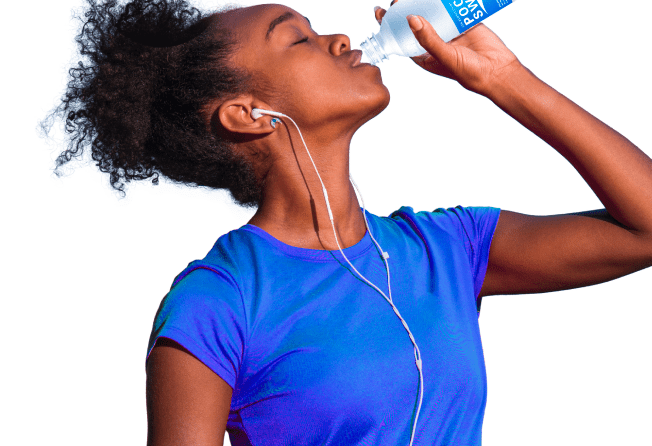 A young lady re-energizing with a bottle of pocari sweat