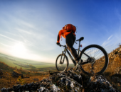 Image of a biker climbing rocks