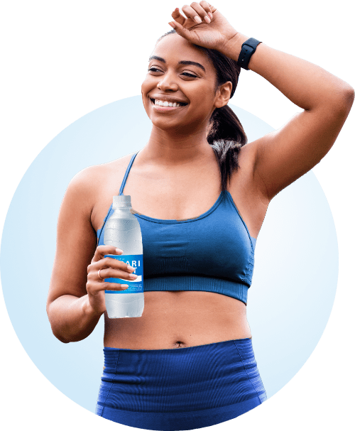 A visibly happy lady holding a bottle of Pocari Sweat while exercising