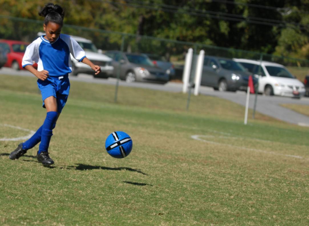 Image of a little black girl playing sports